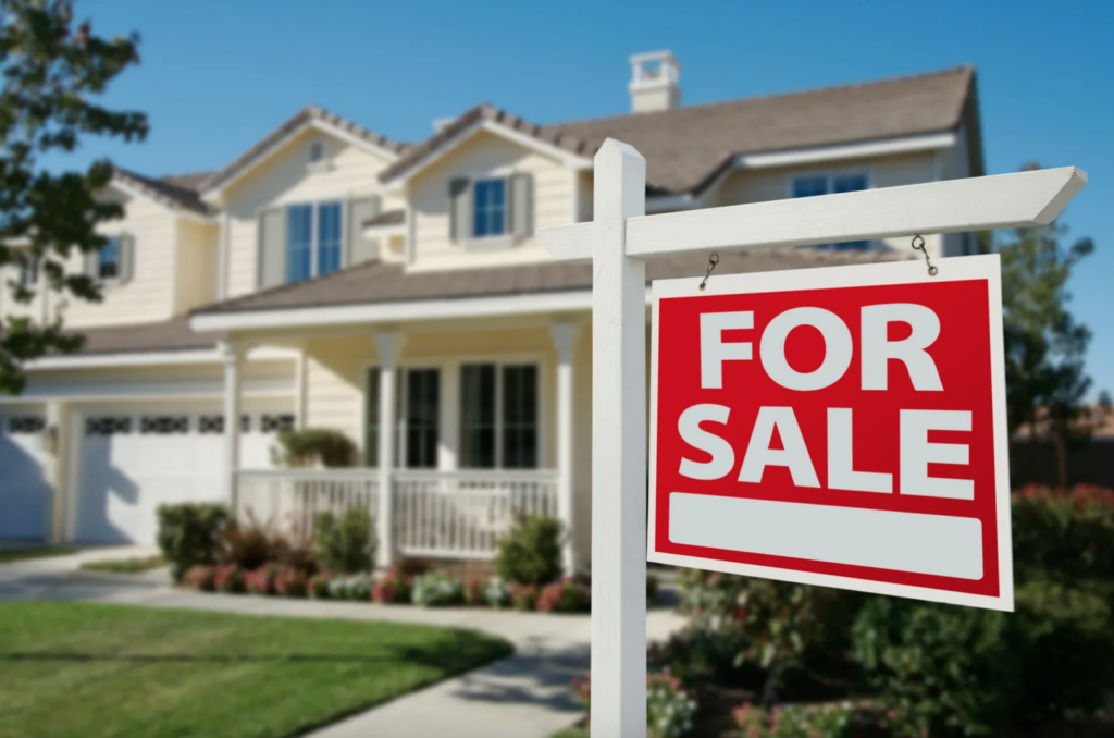 For sale sign in front of a charming house, representing opportunities for first-time home buyers in Utah.
