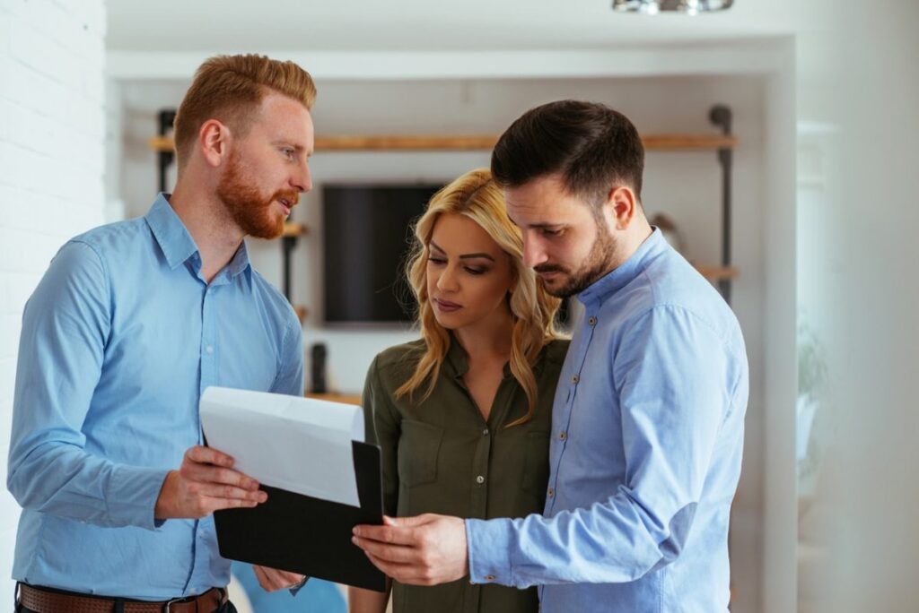 couple communicating with a real estate agent 