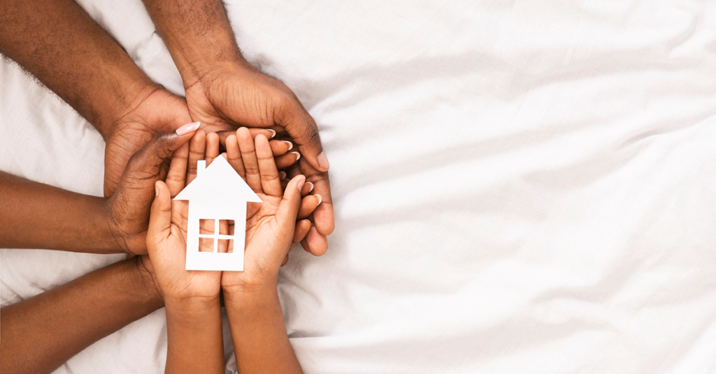 Family of homeowners holding house